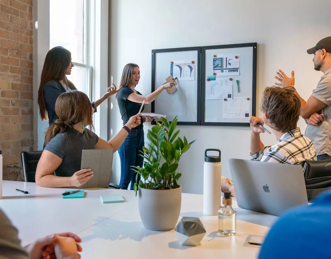 A team reviewing charts and plans together at a board